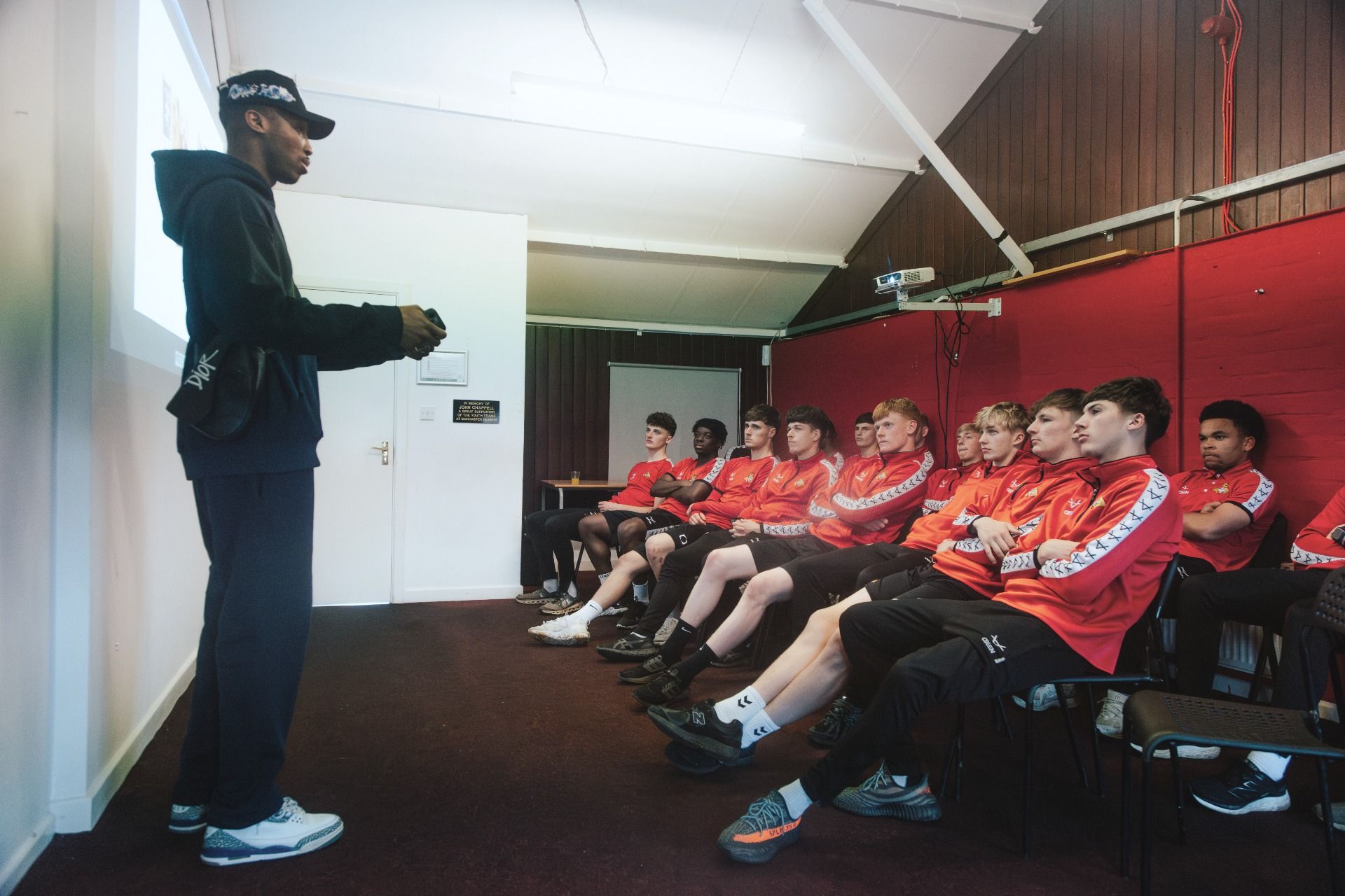 Kofi Josephs speaking with a group of young elite footballers at Doncaster Rovers.